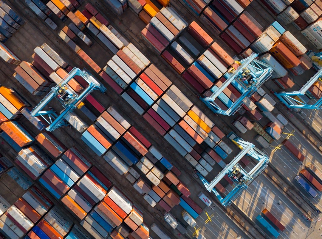 Aerial view of shipping containers and gantry cranes at a container terminal